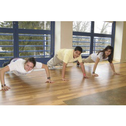 Jessie Mehrhoff '14 shows two middle school students the correct way to do push-ups.