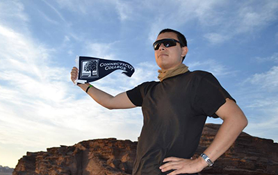 Arabic Studies student with Connecticut College pennant in Jordan