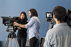 Sean Fine '96 (center) shows Bae Yung Kim '16 how to use an Arri Alexa camera while Juan Pablo Pacheco ’14 films the two with a RED Epic.