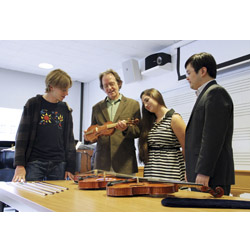 Luthier Karl Dennis (second from left) shows early and modern string instruments in his collection to Jesse Guterman '16, Kelly D'Ancicco '16 and Professor Daniel Lee. Photo by Laura Cianciolo '16.