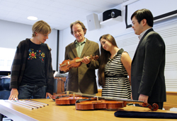 Luthier Karl Dennis (second from left) shows early and modern string instruments in his collection to Jesse Guterman '16, Kelly D'Ancicco '16 and Professor Daniel Lee. Photo by Laura Cianciolo '16.