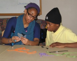 Marline Johnson '13 and a student work on an art project as part of ENRICH, the College's new extended learning time program for students at New London's Bennie Dover Jackson Middle School.