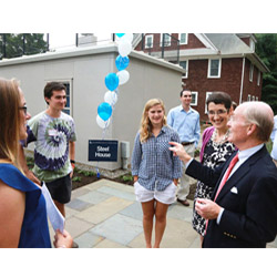 President Higdon, right, speaks to students and faculty at the reopening of the College's historic Steel House, home to the new Office of Sustainability.