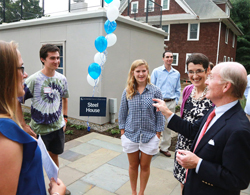 President Higdon, right, speaks to students and faculty at the reopening of the College's historic Steel House, home to the new Office of Sustainability.