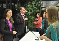 Caitlyn Turgeon '08 (left), human capital consultant at Deloitte Federal Consulting, spoke with students after a panel discussion during the recent