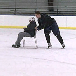 Senior Keith Veronesi takes 10-year-old John-Anthony Washburne skating on the Connecticut College ice.