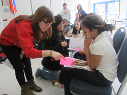 Sophomores Dana Sorkin, Lizz Ocampo, and Kaitlin Cunningham teach Russian to New London middle-schoolers at last year's International Student Expo, which was supported by the Mellon Initiative on Foreign Languages.