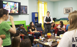 Professor Jen Manion (standing center) greets students during an event in Connecticut College's LGBTQ Center.