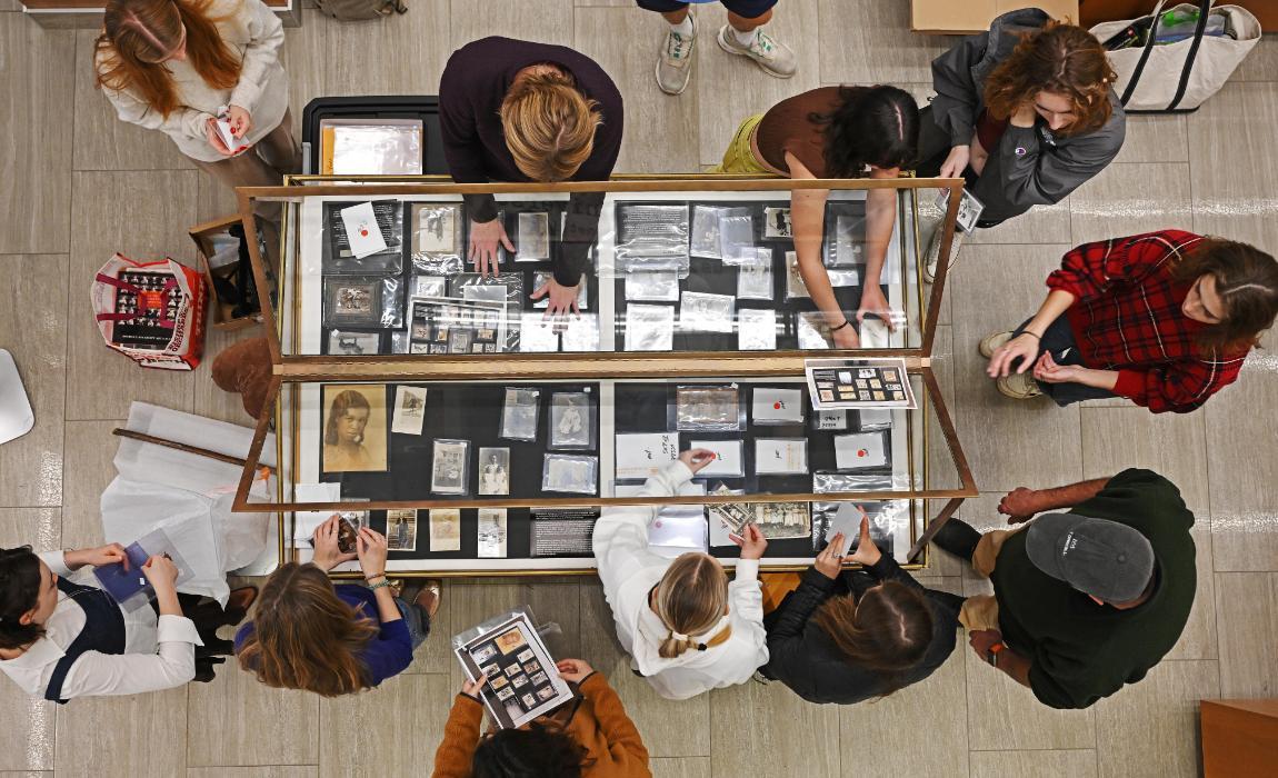 Students organize photos from the college's collection for an exhibition.