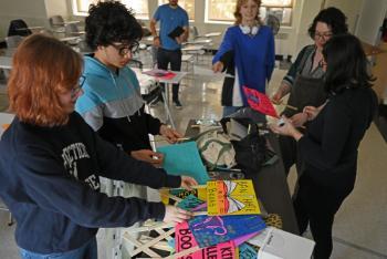 Students handling mini protest signs