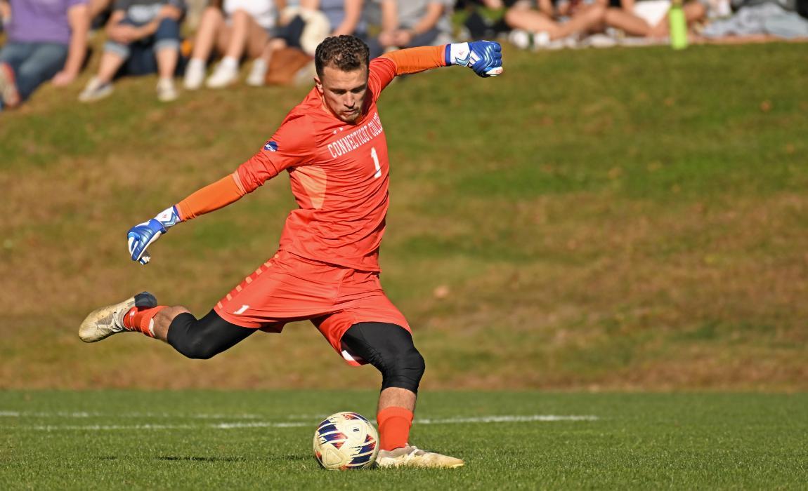 The men's soccer goalie kicks the ball during a match against Bates.