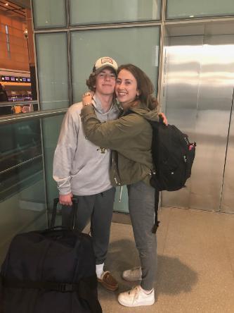 Lexi hugs her brother at the Boston airport