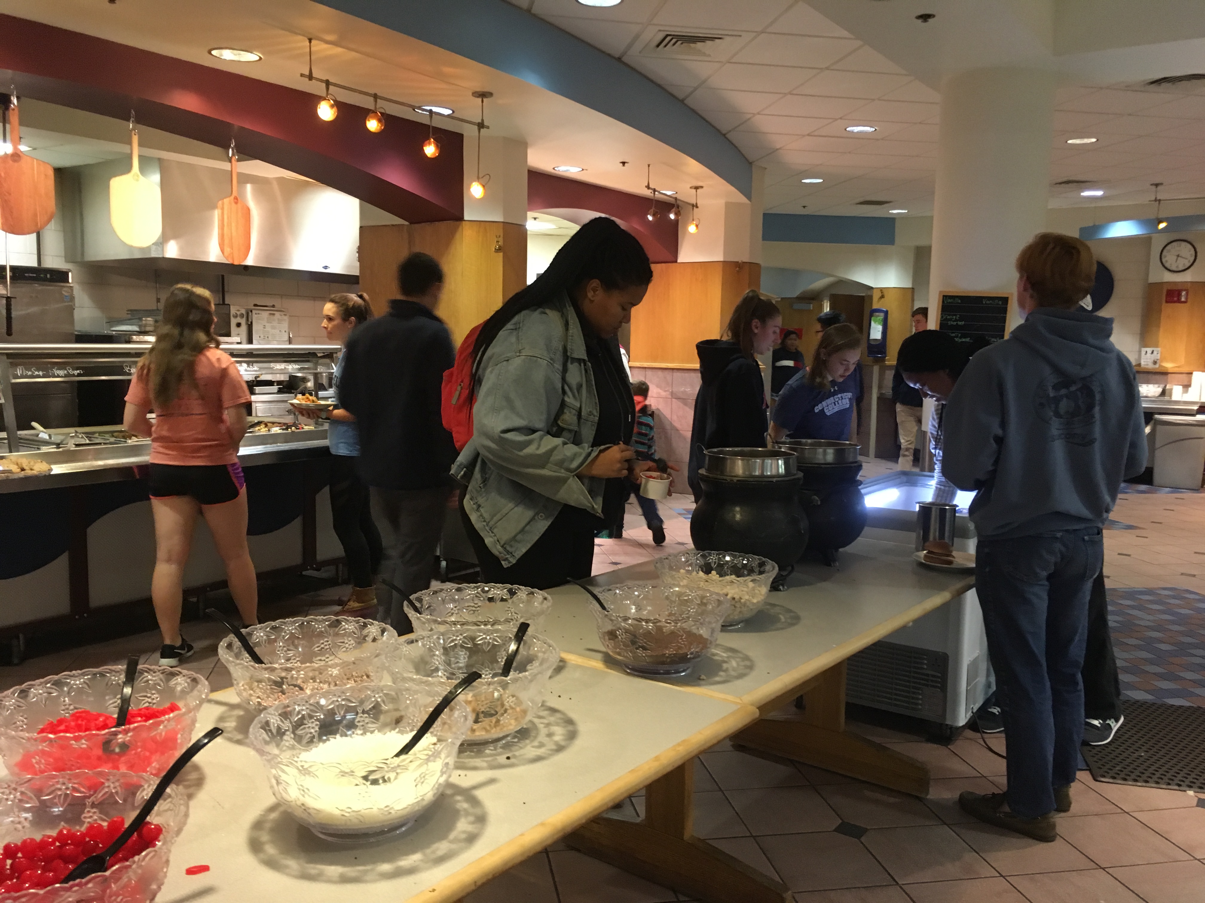 Students pour toppings on top of their sundae's at Harris Dining Hall's Sundae Sunday event