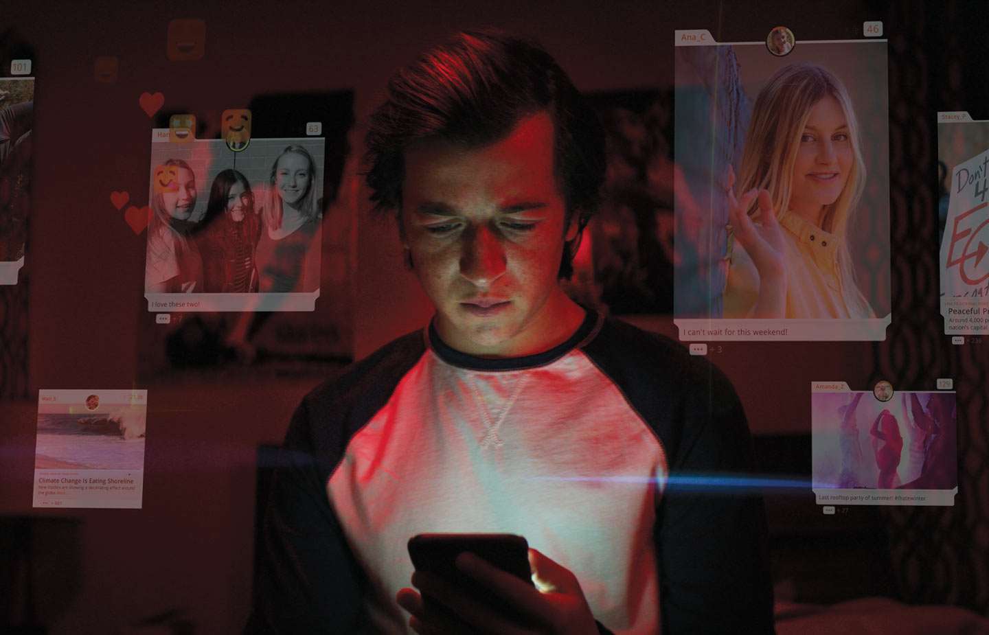 Image of young man looking at his phone in the dark