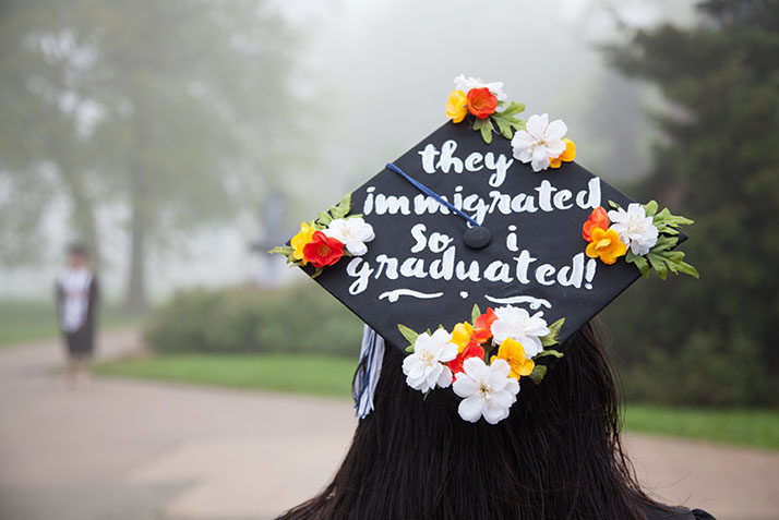 A student wears a graduation cap reading 