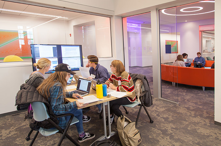 A group of students work together in the collaboration space of the Global Commons.