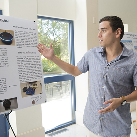 George Tilneac '18 describes his work with Jaleel Watler '19 to develop an autonomous double robot. Tilneac and Watler worked with computer science professors Gary Parker and James Lee on the research. 