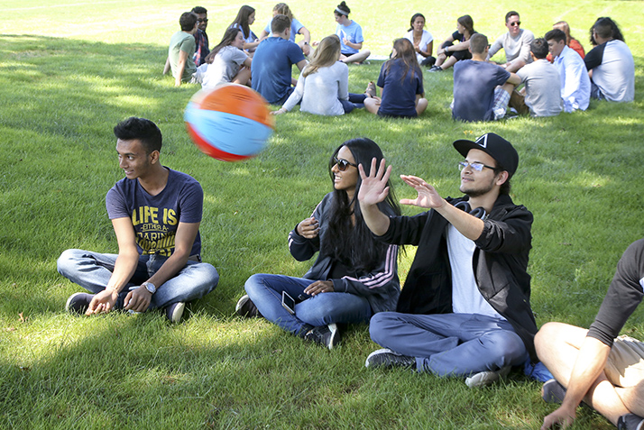 New students pass around a beach ball as part of an icebreaker activity. 