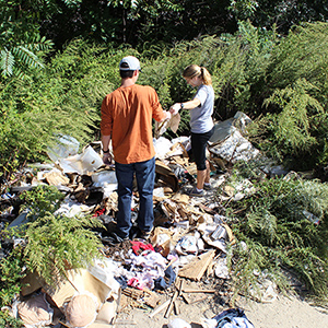 Corbin Maynard '17 and Avery Thomas '16 record a large assemblage of personal possessions discarded in an empty lot.