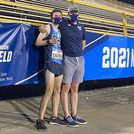 Matt Carter ’23 and Head Men's Track and Field Coach Luke Maher at the NCAA Division III Championship meet. 