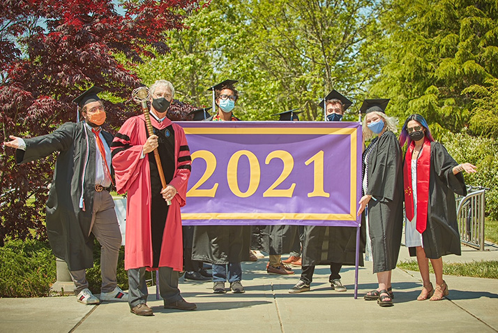 Members of the procession hold the Class of 2021 flag.