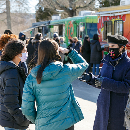 President Katherine Bergeron, right, speaks with students during a food truck event on campus. 
