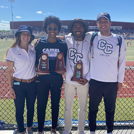 Malissa Lindsey '23 and Jeffrey Love '23 pose with their coaches and their NCAA Championship trophies.