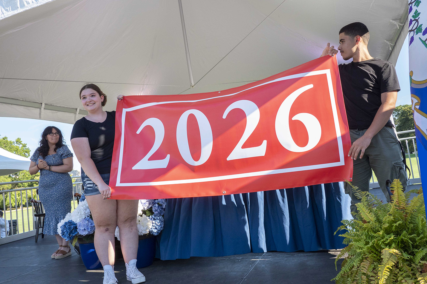 Kersyn McBride '26 and Josiah Rondon '26 present the Class of 2026 banner