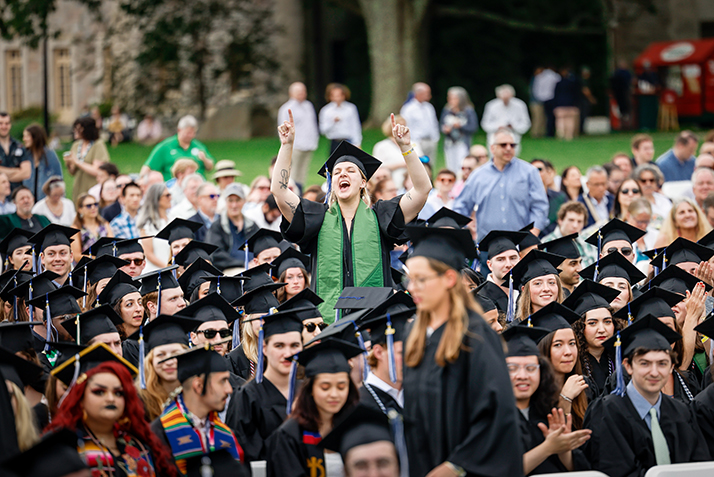 A graduate cheers during the event.