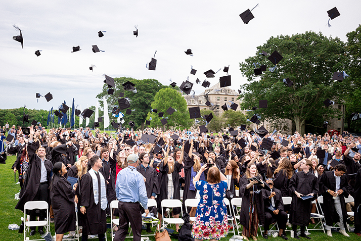 Graduates toss their caps.