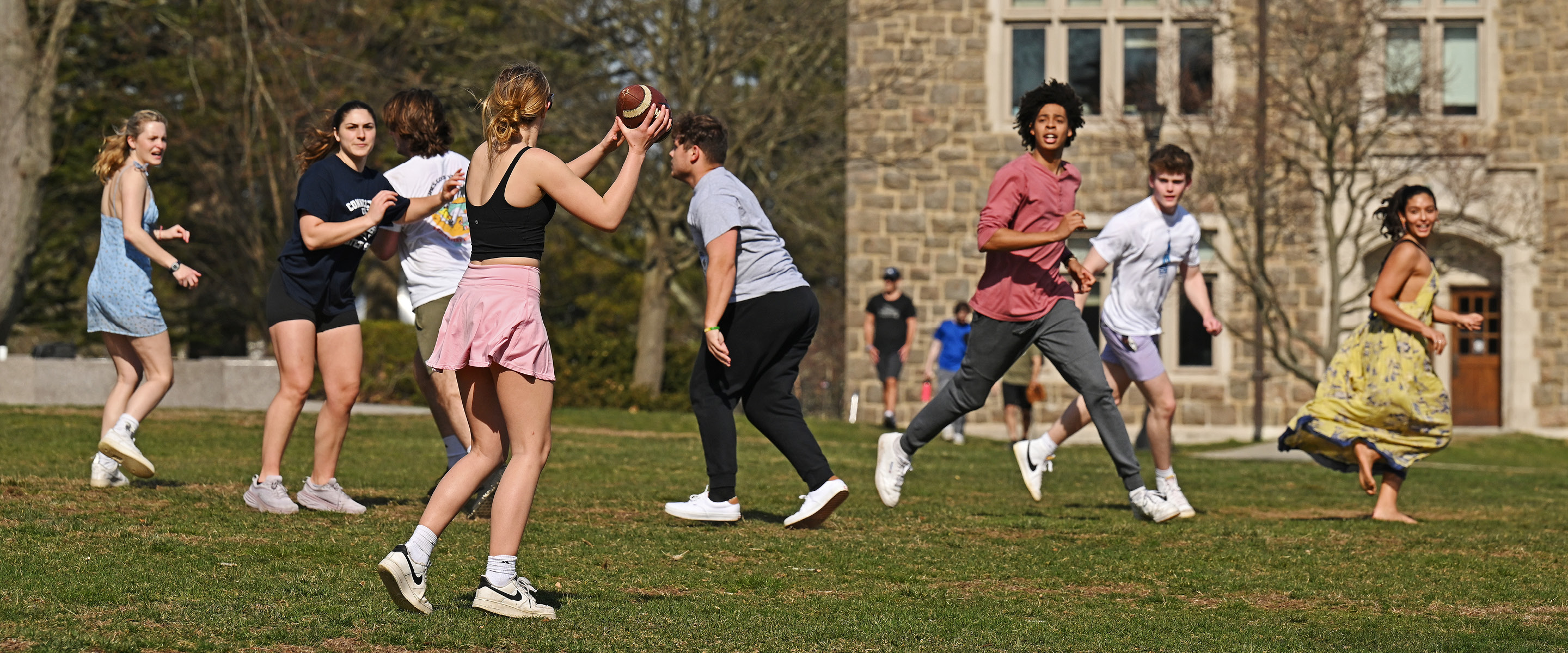 Students play touch football on Tempel Green