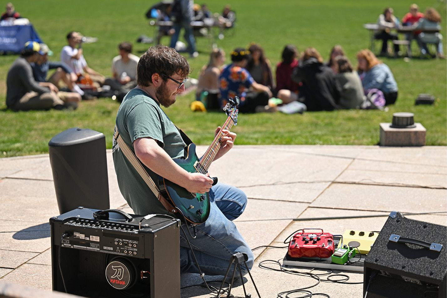 A guitarist plays at Earth Day on Tempel Green