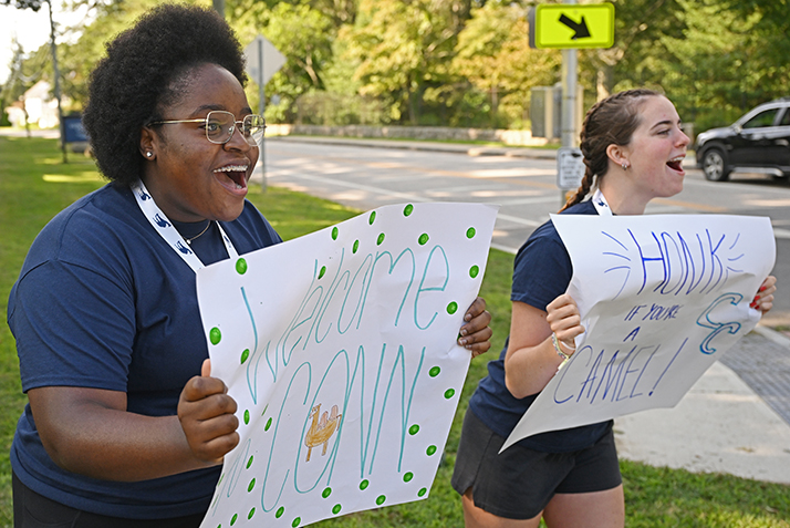 Student leaders cheer as new students arrive on campus.