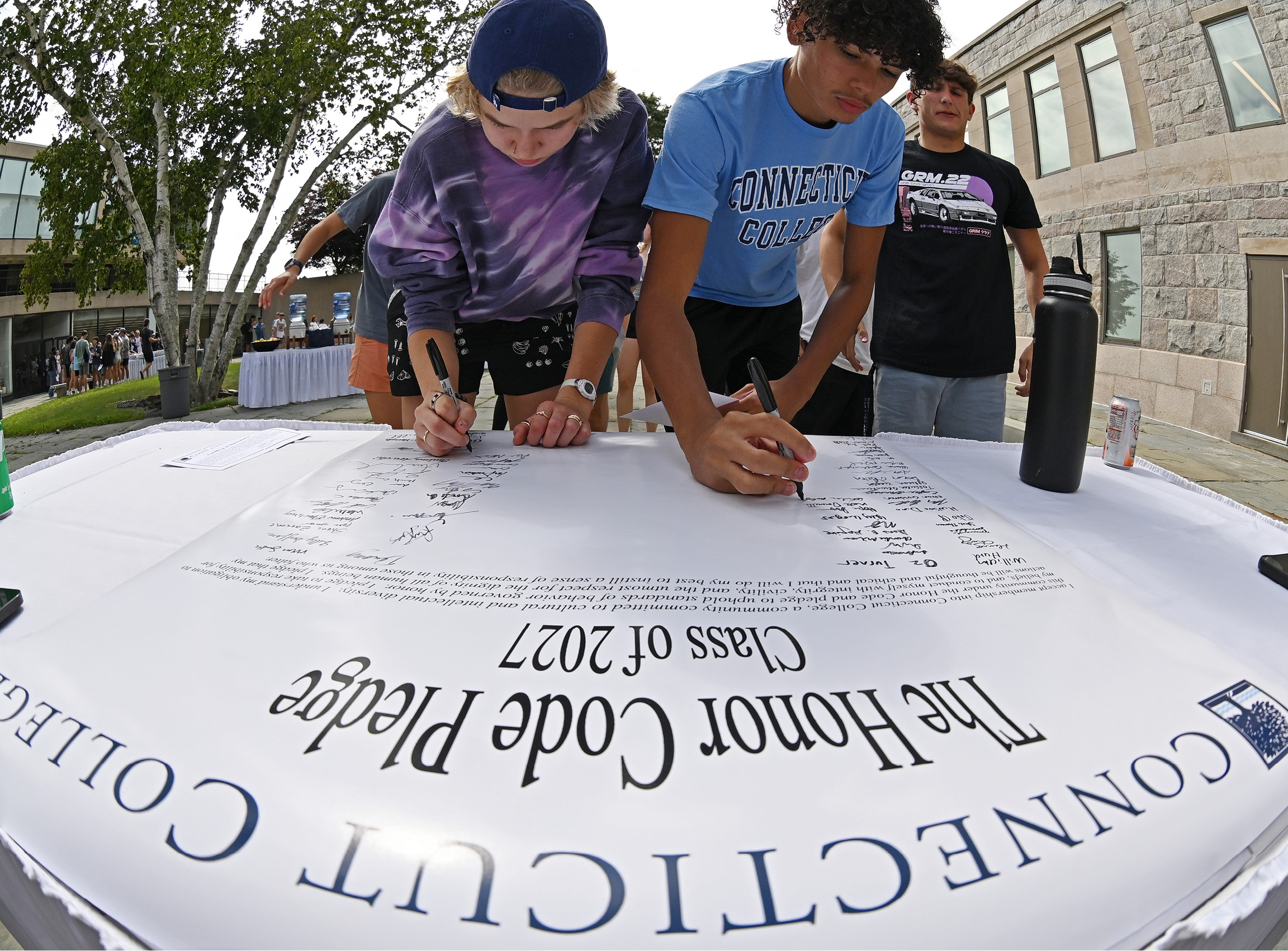 Fish-eye lens shot of students signing the Honor Code