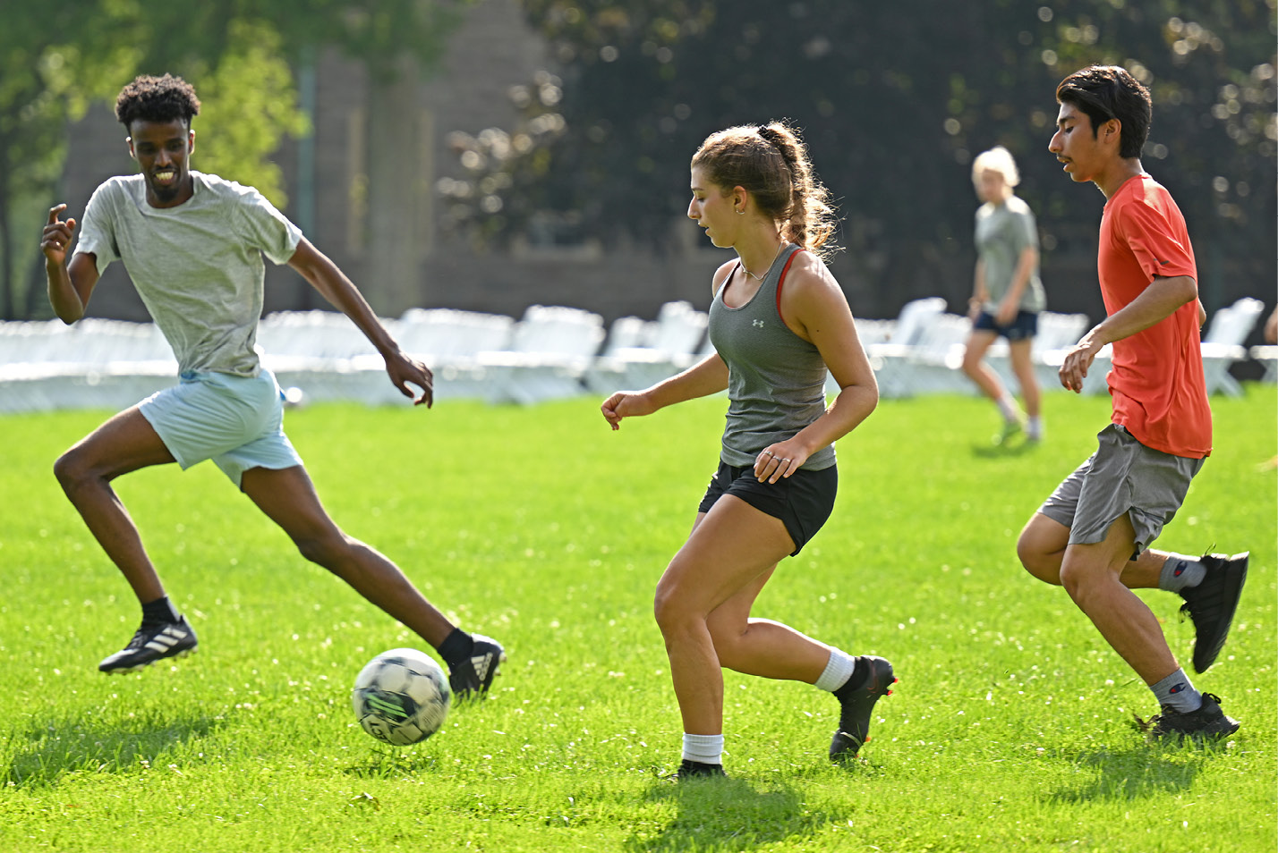 Male and female students playing club soccer on the Green.