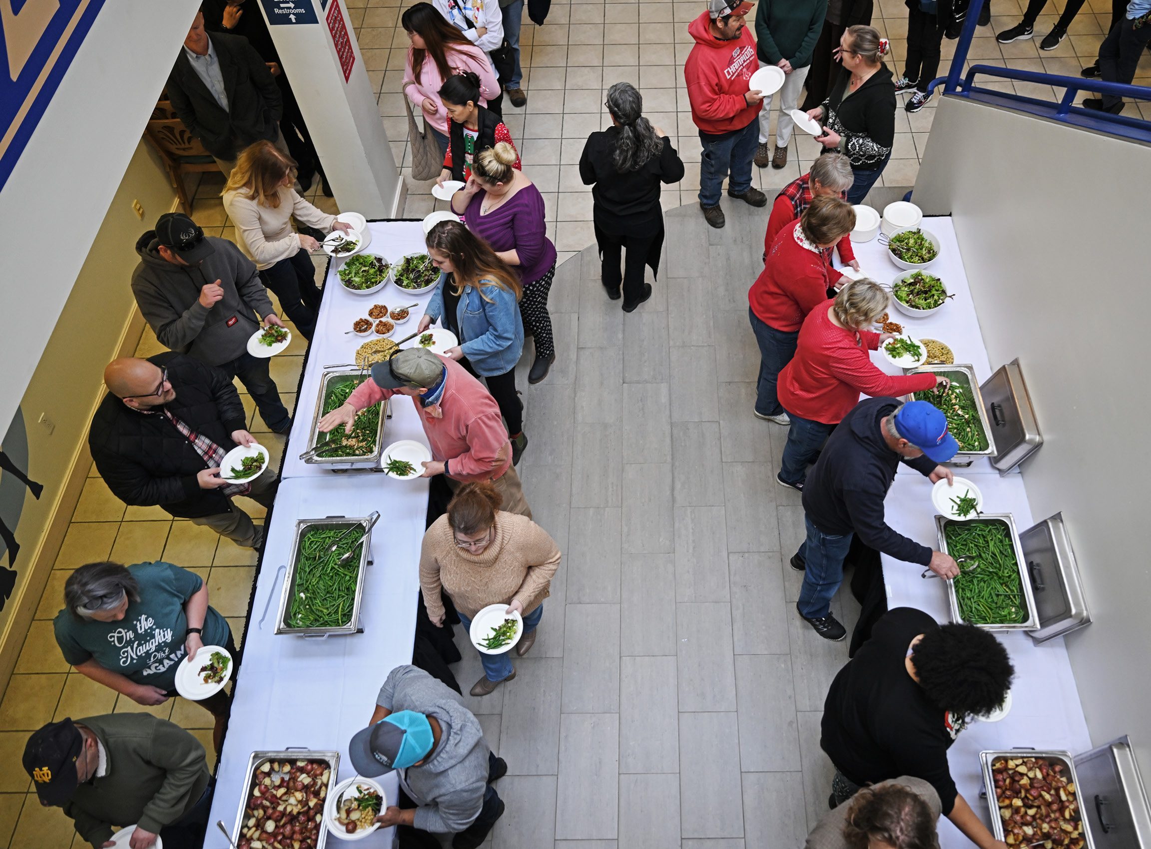 Overhead shot of staff getting food at the year-end holiday party.