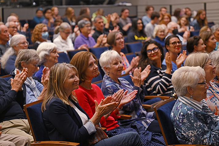 Members of the community clap during the One Book One Region event.