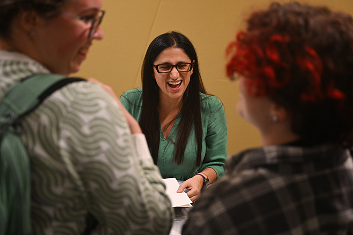 Mona Hanna-Attisha shares a laugh with students while signing copies of her book, 