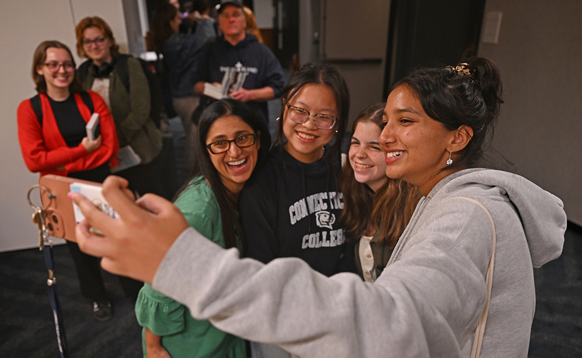 Mona Hanna-Attisha takes a selfie with students during her book signing.