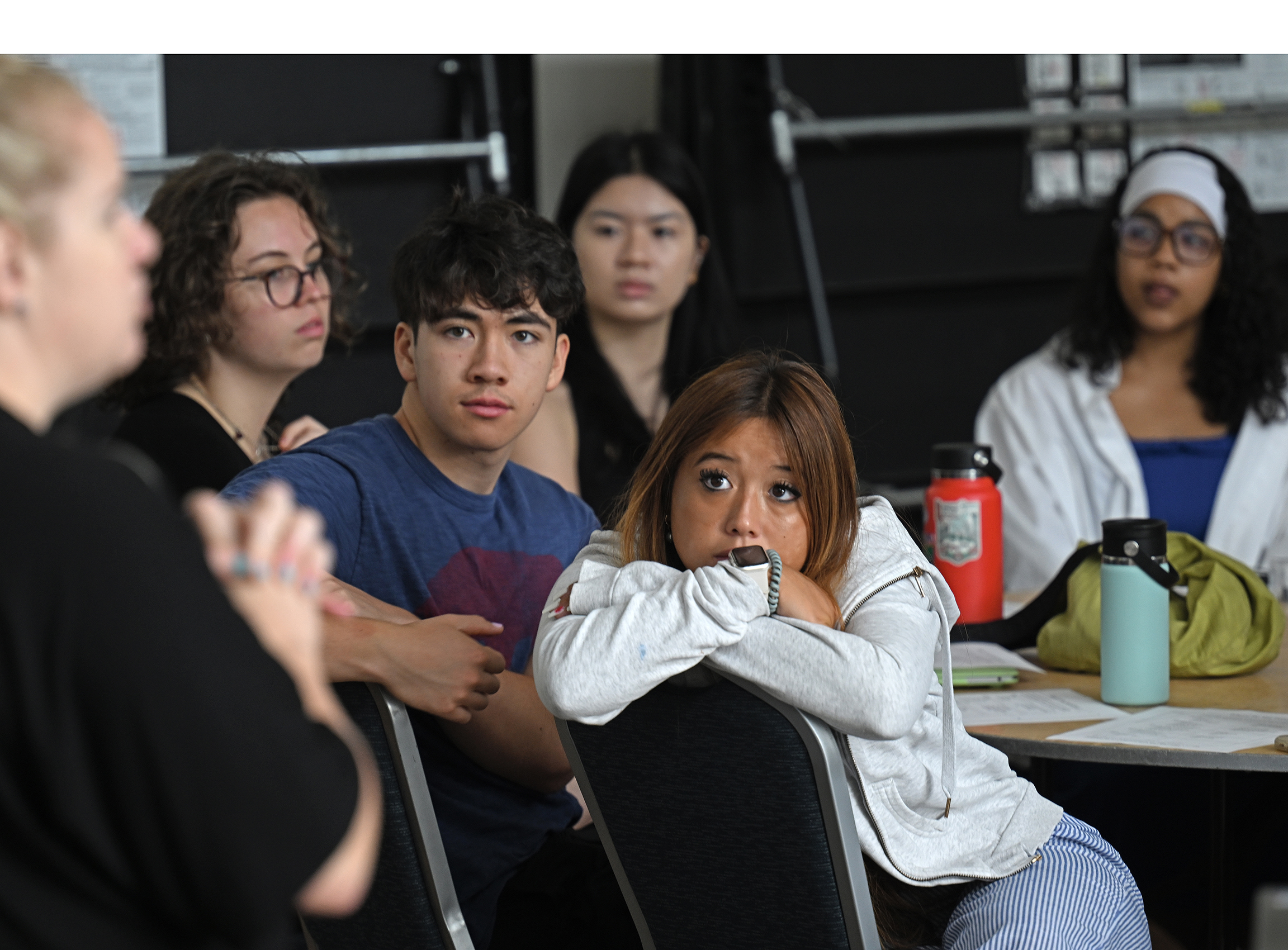 Seated students look and listen during a training session.