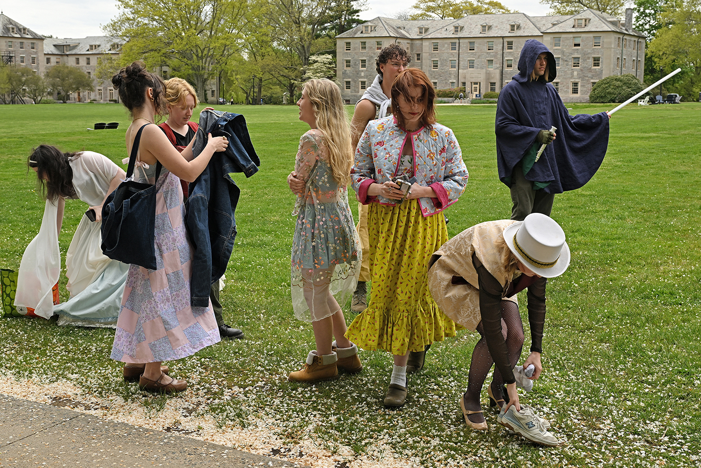 Students in costume gather their things after a photo session