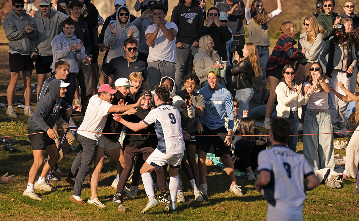 Members of the team celebrate with fans.