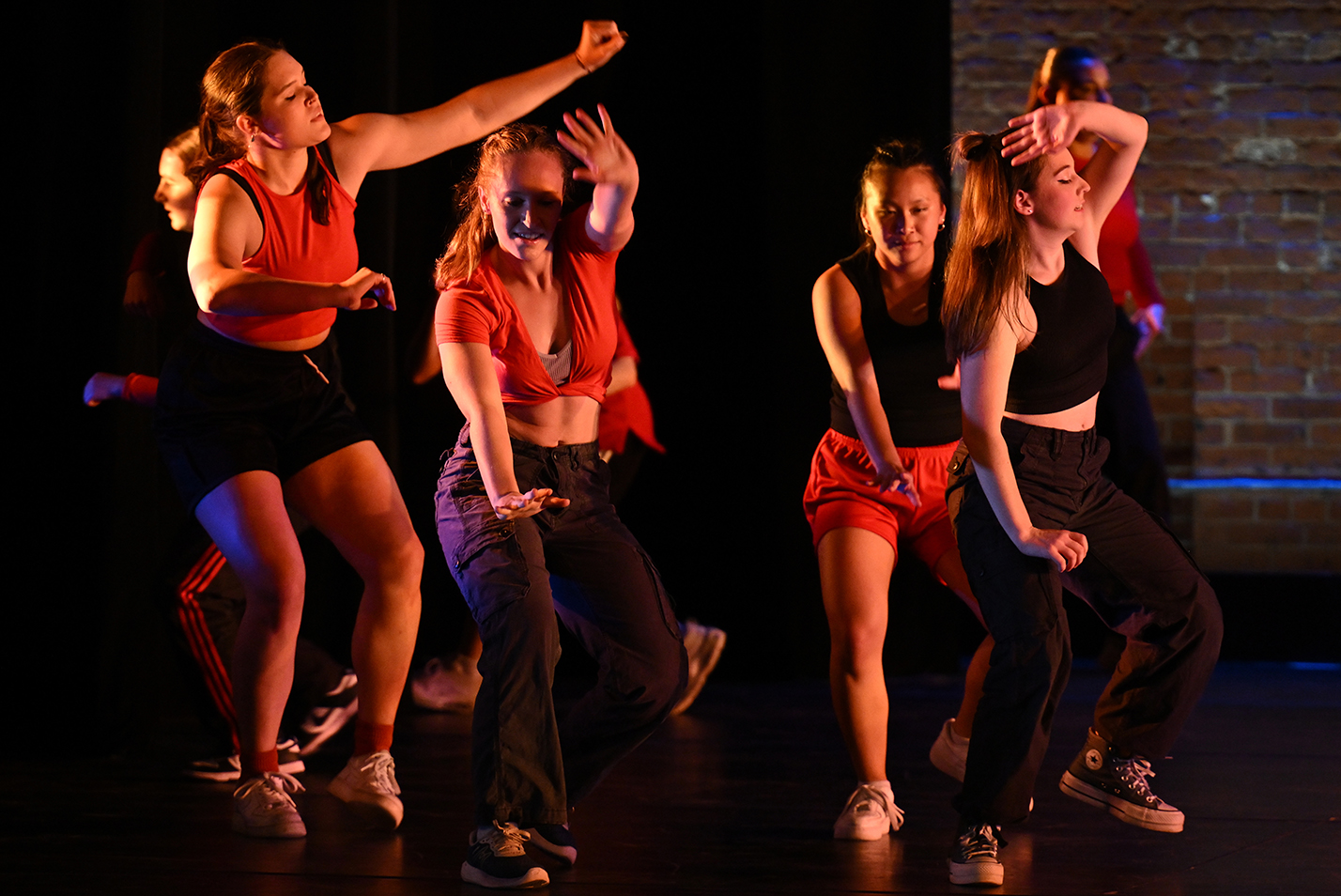dancers in red and black perform a hip hop piece