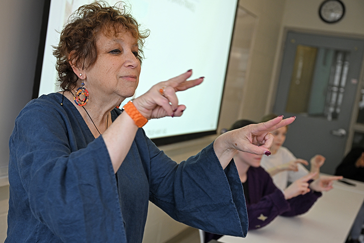 A professor teaching American Sign Language