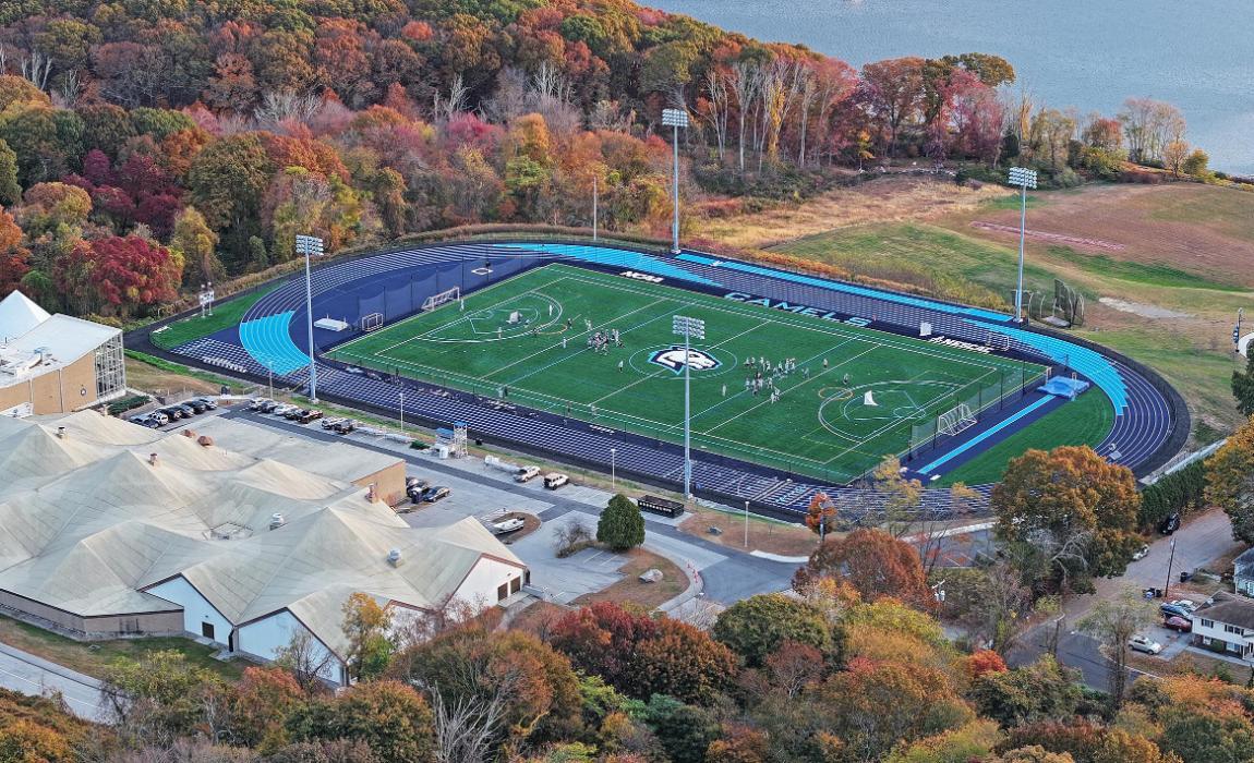 Aerial view as a lacrosse team practices on a newly renovated turf field.