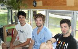 Tyler Dunham '09, left, with friends on their bus powered by vegetable oil