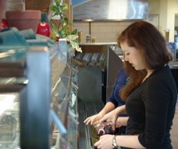 A student helps herself to some Connecticut black currant juice at the new local and regional salad bar in Harris Refectory.