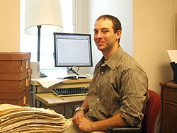 Kevin Hartnett '10 works with stacks of documents from the 19th century.