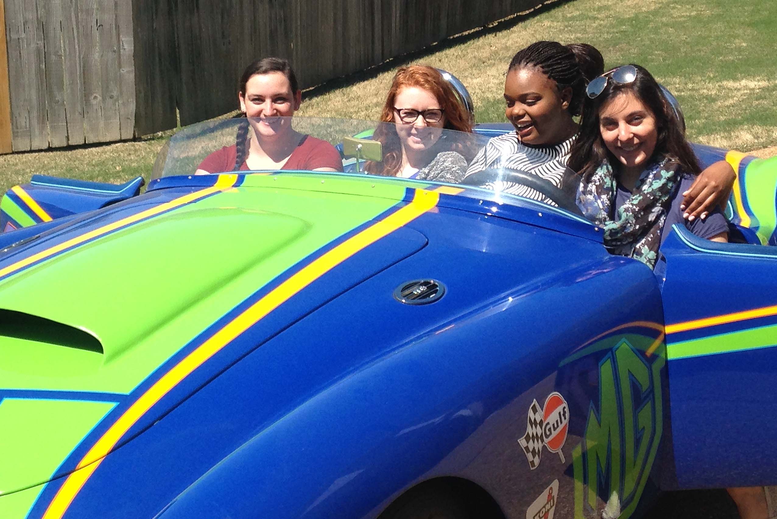 BRG students at NCUR conference in a race car.